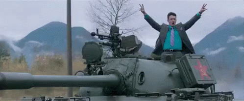 Tank avec un homme qui balance les bras en signe de victoire